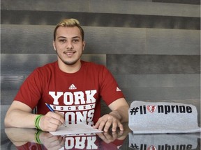 Humboldt Broncos' forward Kaleb Dahlgren signs his letter of intent to play hockey with York University.