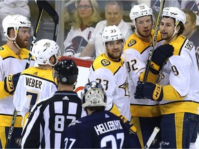 Nashville Predators forward Filip Forsberg (right) is congratulated after scoring on Winnipeg Jets goaltender Connor Hellebuyck during Game 6 of their NHL playoff series in Winnipeg on Mon., May 7, 2018. Kevin King/Winnipeg Sun/Postmedia Network