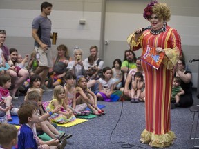 China White reads a story book to a crowd during the Pride event, Drag Queen Story Time, at Frances Morrison Library  in Saskatoon on Saturday, June 9, 2018.