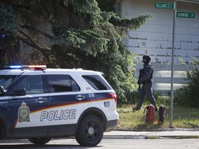 Police block off a house on the corner of Hilliard Street and Dunning Crescent where a man barricaded himself after allegedly attacking a City of Saskatoon grader in Saskatoon, SK on Wednesday, June 13, 2018.