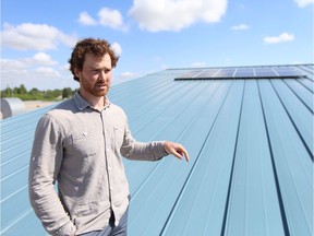 Teacher Michael Prebble shows off the solar panels installed on the roof of Tommy Douglas high school in Saskatoon on June 8.