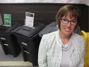 Brenda Wallace, the City of Saskatoon's director of environmental and corporate initiatives, stands next to three different garbage cart sizes at city hall on Monday, June 11, 2018.