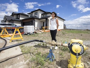 Aspen Ridge neighbourhood resident Susan Serrano stands for a photographer near a city hydrant outside of her home in Saskatoon, SK on Tuesday, June 12, 2018.