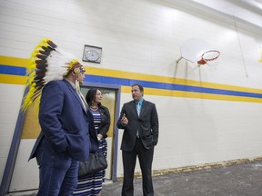 E.D. Feehan Catholic High School principal Brandon Stroh, right, speaks with Saskatoon Tribal Council Chief Mark Arcand, left, and Diane Boyko, chair of the Greater Saskatoon Catholic Schools board, in the school's smaller gym, which is currently undergoing renovations.