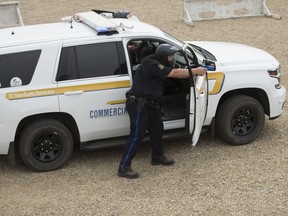 Members of the Commercial Vehicle Enforcement act out mock scenarios  during a Ministry of Highways and Infrastructure event showcasing the tactical training Commercial Vehicle Enforcement officers are receiving prior to joining the provincial Protection and Response Team  at a private range south west of Saskatoon, SK on Thursday, June 14, 2018.