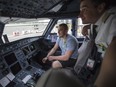 Humboldt Broncos bus crash survivor Kaleb Dahlgren, left, is shown the flight deck of an airplane by Air Canada pilot Mathieu Dussault during their layover in Calgary, before heading to Las Vegas for the NHL awards, in Calgary, AB on Monday, June 18, 2018.