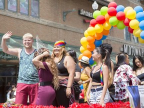 Participants march down the street during the Saskatoon Pride Parade held downtown in Saskatoon on Saturday, June 23, 2018.
