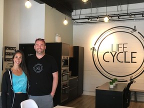 Jess Bonish and Deyton Bonish pose in the lobby of LIFEcycle Spin Studio on Broadway Avenue in Saskatoon on June 21, 2018. (Erin Petrow/ Saskatoon StarPhoenix)