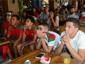 Moroccan football supporters react as they watch their national team play in their Russia 2018 World Cup Group B football match against Portugal at a sports cafe in Marrakech on June 20, 2018.