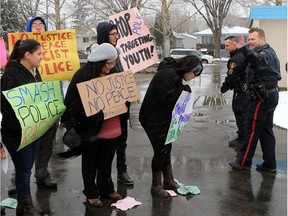 About 60 people gathered in Pleasant Hill Park in Saskatoon to rally against the practice of police carding before marching to city hall on March 15, 2016. Two police service members briefly visited the rally as well.