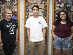 Thom Collegiate teacher Dawne Cassell, from left, stands with two Grade 12 students, Kegan Sangwais and Israel Le Caine in front of a reconciliation-themed art project in the hallway at Thom.