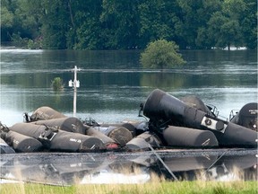 Tank cars carrying crude oil are shown derailed about a mile south of Doon, Iowa, Friday, June 22, 2018. About 31 cars derailed after the tracks reportedly collapsed due to saturation from flood waters from adjacent Little Rock River.