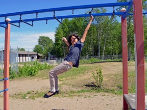 Elizabeth Roberts, an eight-year-old girl from the Lac La Ronge Indian Band who was born missing part of her right arm, plays in a playground in La Ronge in May 2018. Elizabeth says she hopes to travel the world one day as a competitive para skier.