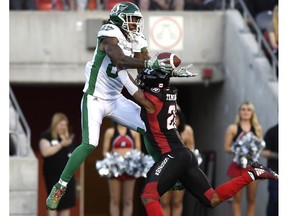 The Ottawa Redblacks' Corey Tindal, right, prevents the Saskatchewan Roughriders' Naaman Roosevelt from making a catch in the end zone during Thursday night's CFL game. The pass ended up being intercepted by Loucheiz Purifoy.