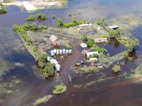 Floodwaters surround a farmstead near Gainsborough in southeast Saskatchewan in July 2014. New regulations aim to mitigate the impact of agricultural drainage projects on downstream landowners.