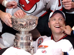 In this June 9, 2003 file photo, New Jersey Devils goalie Martin Brodeur gets his cheek pinched after the Devils beat the Anaheim Mighty Ducks in seven games to win the Stanley Cup.