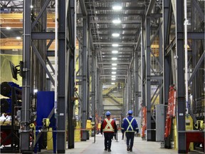 Workers walk down a corridor at Suncor's Fort Hills facility north of Fort McMurray, Alta. on Friday, April 6, 2018. Vincent McDermott/Fort McMurray Today/Postmedia Network