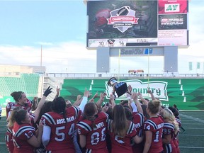 Members of the Regina Riot celebrate their Western Women's Canadian Football League championship on Sunday at Mosaic Stadium.