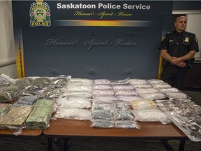 Inspector Dale Solie stands next to the various drugs on display during a media event showcasing a significant seizure of illegal drugs at the Saskatoon Police Headquarters in Saskatoon, SK on Thursday, June 7, 2018.