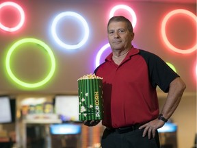 Wilf Runge, manager of the Rainbow Cinema, stands in the lobby with a bag of what he calls the best popcorn in Regina.
