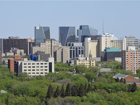 Regina downtown buildings rise above the trees as seen from atop the Saskatchewan Legislature.