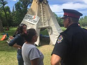 Protesters from the Justice For Our Stolen Children camp in front of the Legislative Building speak to a Regina police officer as attempts were made to remove the last of the camp after 111 days.
