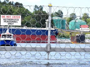 A security vessel patrols the fence of Trans Mountain marine terminal, in Burnaby, B.C.