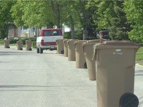 City of Regina trash bins line a street.