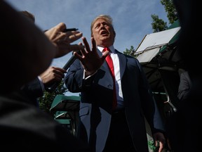 President Donald Trump speaks to reporters on the North Lawn of the White House, Friday, June 15, 2018, in Washington.