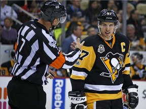 In this Feb. 19, 2017 file photo Pittsburgh Penguins' Sidney Crosby (87) listens to referee Garrett Rank (7) during the second period of an NHL hockey game against the Detroit Red Wings in Pittsburgh. Rank, a full-time NHL referee who played only four rounds of golf during the hockey season, was co-medallist at his qualifying site in Georgia and will play his first U.S. Open this week. Rank, of Elmira, Ont., worked 73 games during the regular season and three playoff games in his second NHL season. But his golf resume is just as impressive. He is a three-time Canadian Mid-Amateur Champion and represented Canada at the Pan-Am Games in 2015.