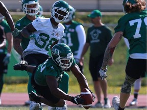 Eric Striker, shown intercepting a pass during training camp, was traded by the Roughriders on Tuesday.