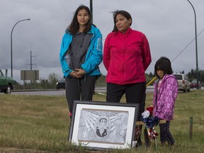 In July 2018 Agatha Eaglechief, centre, stands behind a memorial for her son, Austin Eaglechief, who died in 2017 following a high speed police chase that ended at Airport Drive and Circle Drive. Also pictured are Eaglechief's sisters Mercedez, left, and Abez.