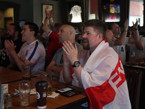 With an English flag around his shoulders, soccer fan Scott Chambers celebrates during an English national team victory over Sweden in the FIFA World Cup on July 7.