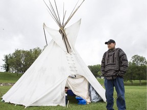 Chris Martell stands in front of a teepee at the Healing Camp for Justice in Victoria Park. Martell, whose son Evander Daniels died when he drowned at a foster home in 2010, is being remembered in Saskatoon July 11, 2018.