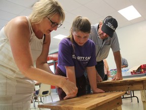 Norine Johnson, left, inspects a pallet table recently constructed by her daughter, Julia Johnson, as her father Todd Johnson, looks on. Julia was one of several people attending the GirlsExploring Trades and Technology (GETT) Camp organized by Saskatchewan Polytechnic. The camp helps girls in between the ages of 12 and 15 get an introduction to the trades in a "safe, supportive environment to explore the tools, equipment and skills needed for a trades and technology career."