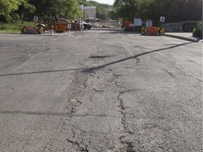 Cracks in the asphalt on Sask. Crescent near Eastlake Avenue in Saskatoon, SK on Tuesday, July 17, 2018. The city is conducting tests to determine the stability of the slope at this location.