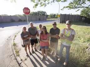 Nutana residents Sarah Neufeld, left to right, Arnold Neufeld, Vicky Neufeld, Kseniga Smiljic, name withheld, and Nathan Jones stand fro a photograph at the intersection of Ninth Street and Lorne Avenue in Saskatoon, SK on Tuesday, July 17, 2018. The group is upset that the city wants to close the street for a year as an experiment, council will vote on the proposal on Monday.