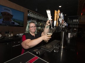 General Manager Aurielle Bleau pours a pint at the Sutherland Hotel, which is set to close on Oct. 30.