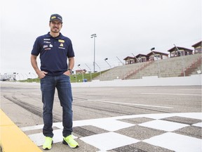 Alex Tagliani stands on the track at Wyant Group Raceway Tuesday morning.
