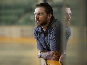 New Humboldt Broncos' head coach and GM Nathan Oystrick stands at the team bench during his first day of work Wednesday.