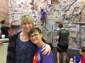 Twyla Sim and her 12-year-old son Brasen stand in front of the rock climbing wall in the Physical Activity Complex at the University of Saskatchewan during the Children's Healthy Heart Camp in Saskatchewan (CHAMPS), a camp that creates a community for children aged seven to 17 who have heart problems, in Saskatoon, Sask. on Wednesday, July 25, 2018.