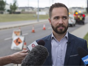 City of Saskatoon director of Roadways and Operation, Brandon Harris speaks to media as roadway workers patch cracks on Taylor Street East near Boychuck Drive in Saskatoon, SK on Thursday, July 26, 2018. On Sunday, July 15th, the crew where narrowly missed by a truck but some specialized patching equipment was damaged.