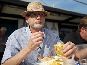 Saskatoon StarPhoenix arts editor Cam Fuller tries a taco during the Foodtruck Wars Flavour Challenge on Sunday, July 29, 2018.