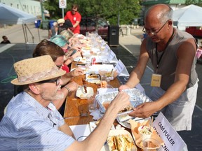 Foodtruck Wars organizer Rick Mah helps hand out food to the judges at the Flavour Challenge on Sunday, July 29, 2018.