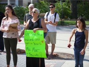 Krista Forsberg, from left, Deb Walker and Sienna Forsberg take part in a protest in Saskatoon on Saturday, July 28, 2018, against the Sask. Party government after it stopped taking applicants for the Saskatchewan Rental Housing Supplement earlier in the month.