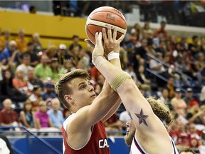 Canada's Nikola Goncin, left, battles for the ball against The United States' Aaron Gouge, right, during first-half men's gold medal wheelchair basketball action at the Parapan American Games in Toronto on Saturday, August 15, 2015.
