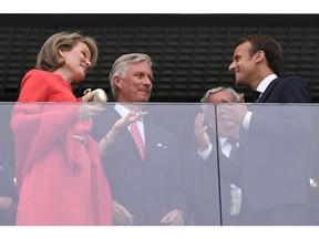 French President Emmanuel Macron (R) greets Belgium's King Philippe (C) and Queen Mathilde as they attend the Russia 2018 World Cup semi-final football match between France and Belgium at the Saint Petersburg Stadium in Saint Petersburg on July 10, 2018.