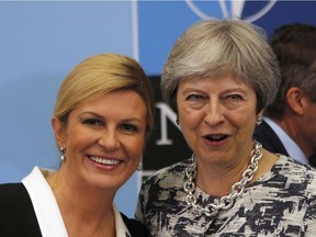 British Prime Minister Theresa May, right, poses with Croatian President Kolinda Grabar Kitarovic, left, prior to a working session of a NATO summit of heads of state and government in Brussels on Thursday, July 12, 2018.