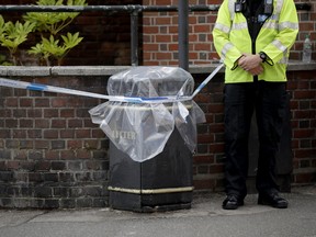 An unidentified British police officer guards a cordon in Salisbury, England on Thursday, July 5, 2018. (AP Photo/Matt Dunham)
