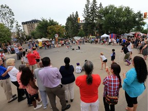 Crowds watch street buskers during the PotashCorp Fringe Theatre and Street Festival on Broadway Avenue.